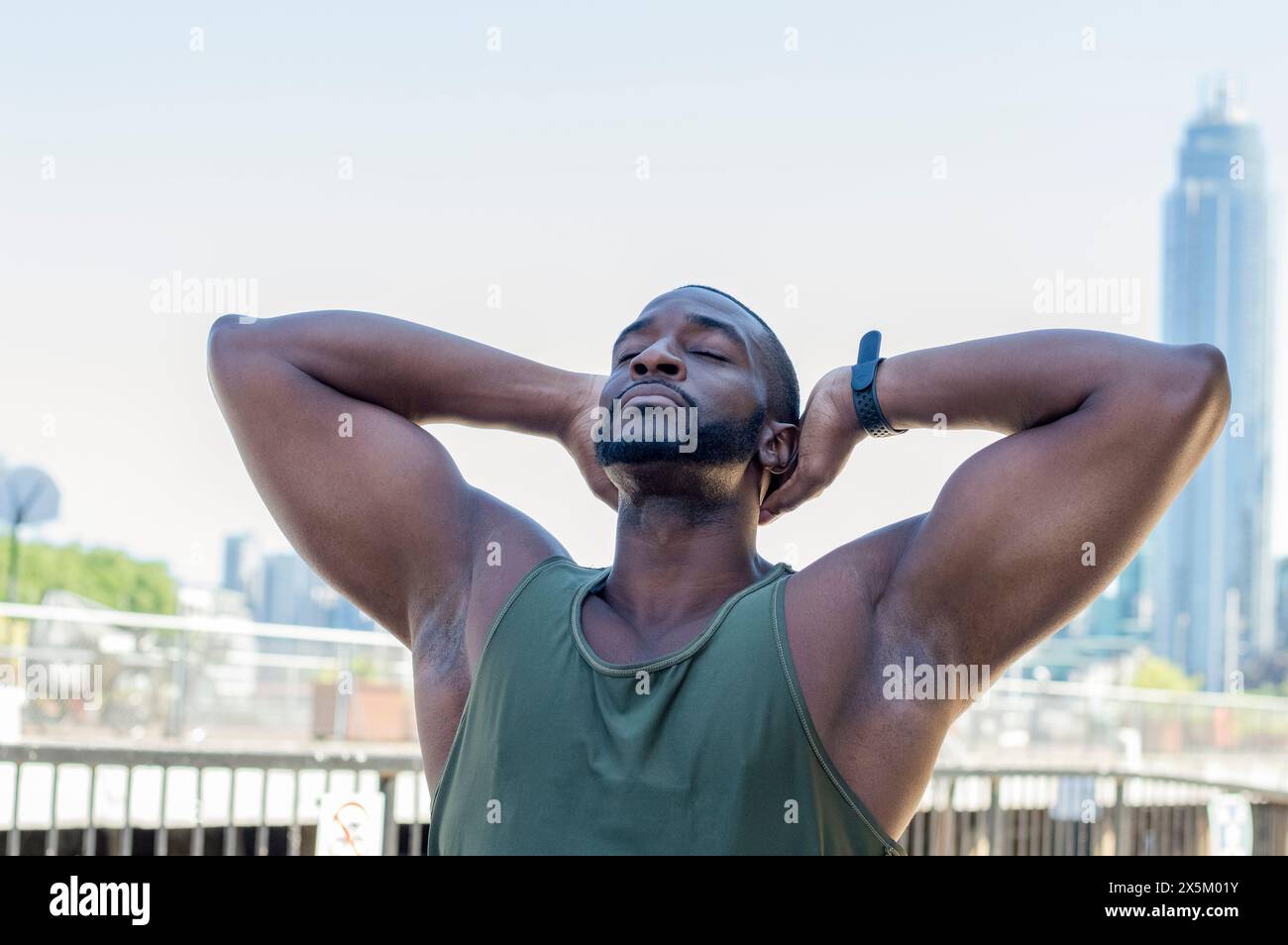 Mid adult man stretching Banque D'Images