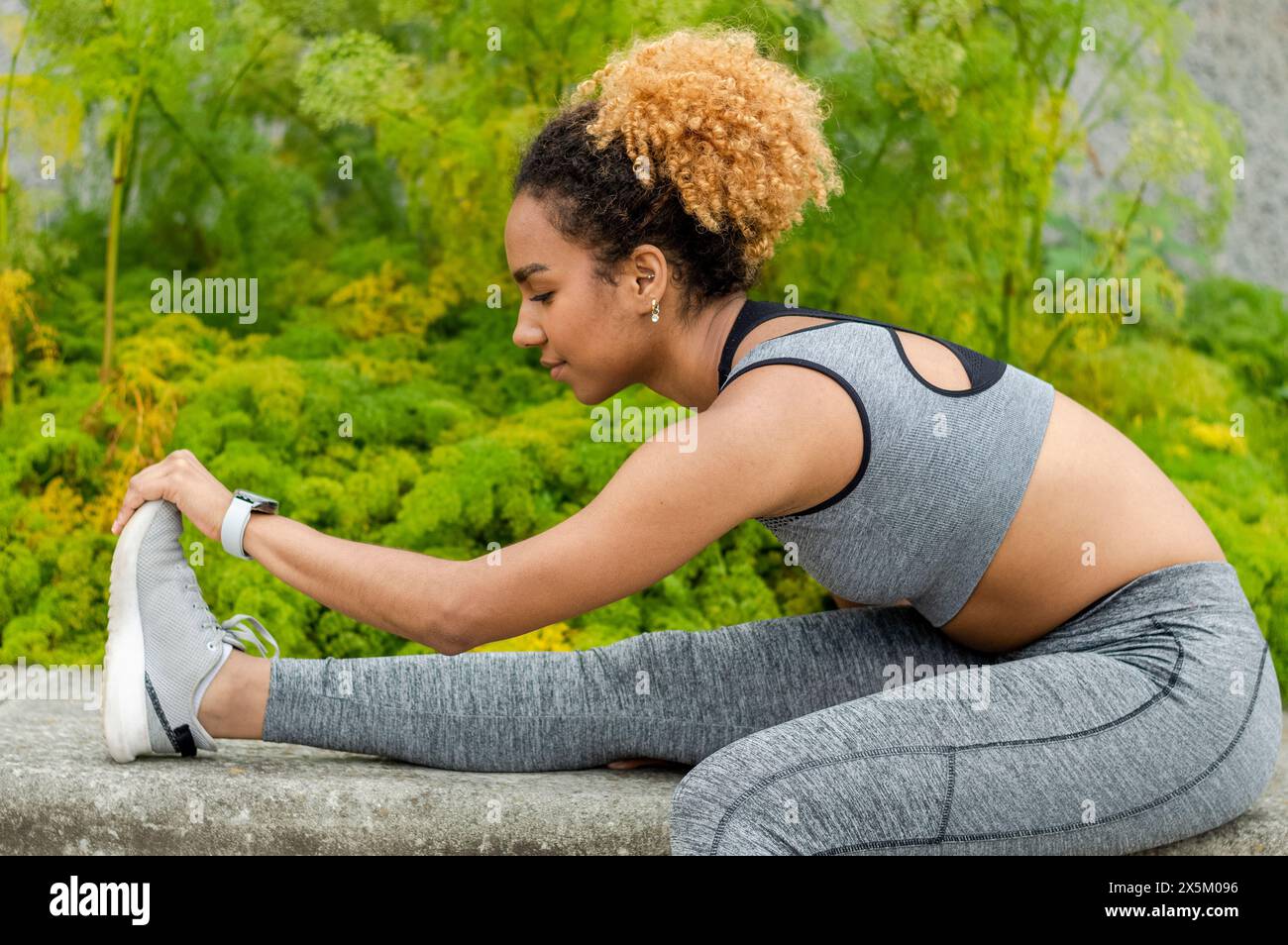 Jeune femme sportive qui s'étire Banque D'Images