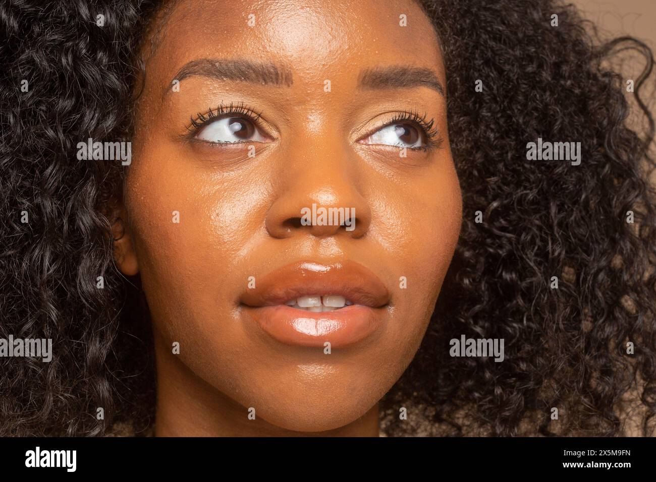 Portrait studio de femme aux cheveux bouclés Banque D'Images