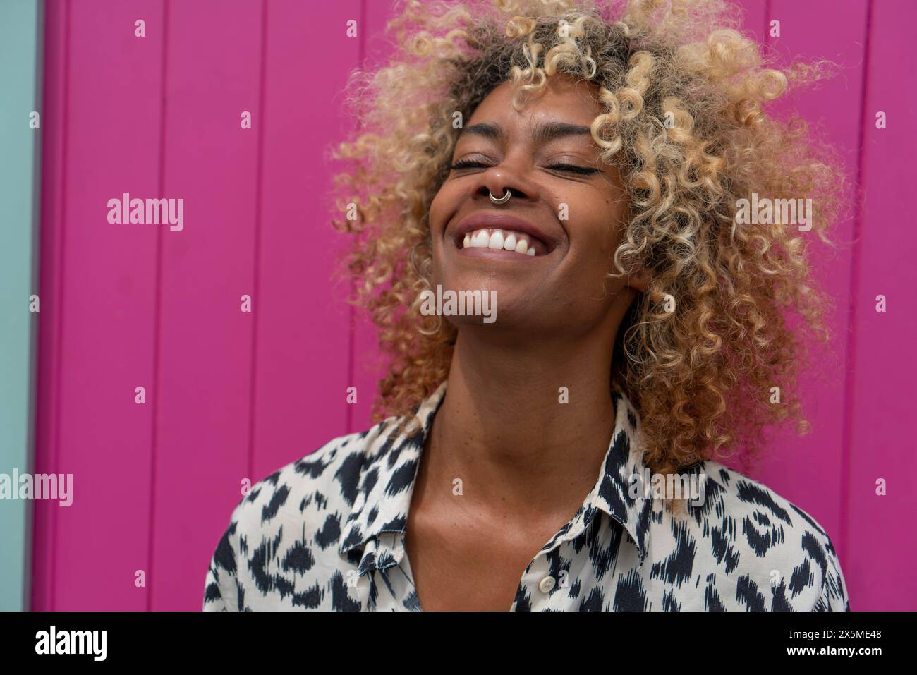 Femme souriante avec des cheveux bouclés Banque D'Images