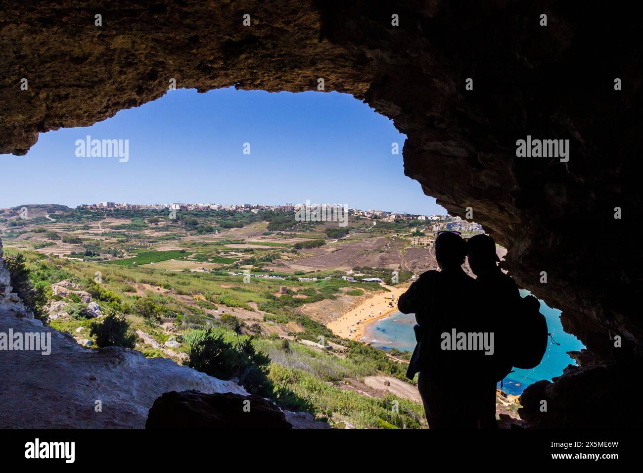 Aventure palpitante en plein air avec une grotte cachée, d'imposantes falaises et un ciel d'été expansif Banque D'Images