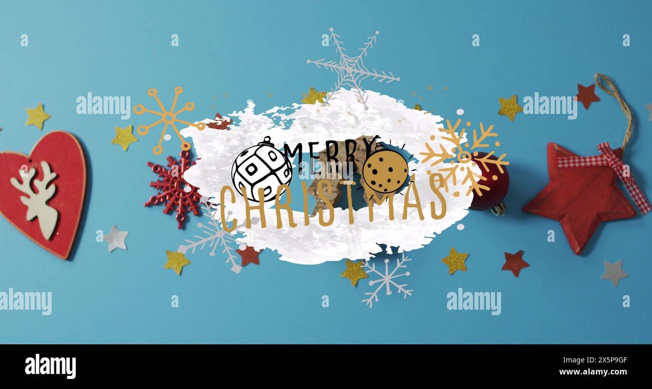 Les décorations des fêtes entourent le message Joyeux Noël sur bleu Banque D'Images