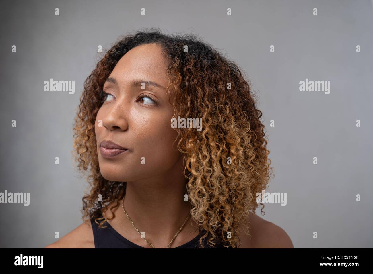 Portrait de femme aux cheveux bouclés et aux yeux bruns Banque D'Images