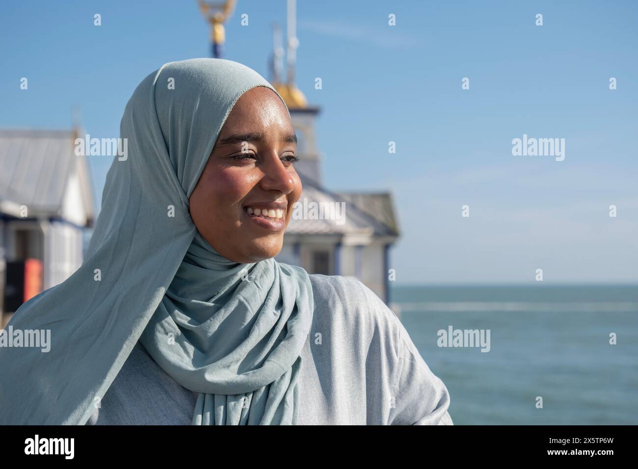 Portrait de femme musulmane réfléchie regardant la mer un jour ensoleillé Banque D'Images