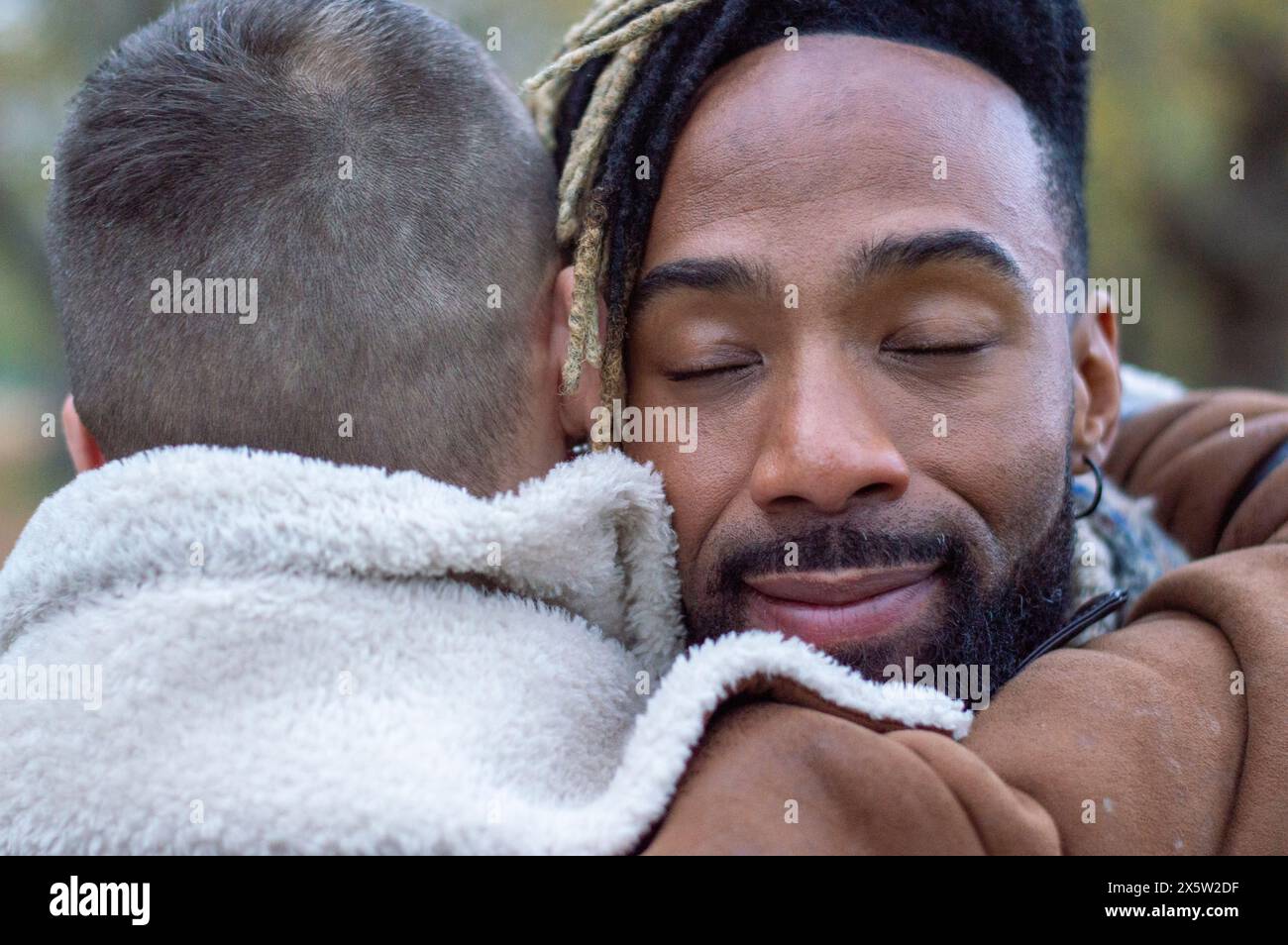 Mi-hommes adultes embrassant, gros plan Banque D'Images