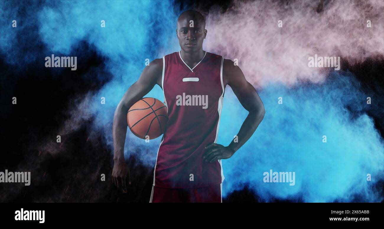 Image de poudres colorées au-dessus d'un joueur de basket-ball Banque D'Images