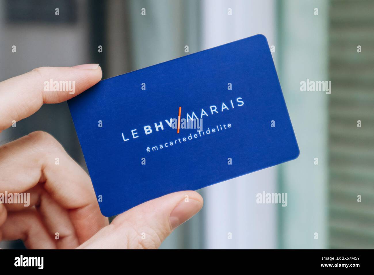 Nice, France - 27.2024 : la main d'un homme tient une carte du magasin BHV Marais Banque D'Images
