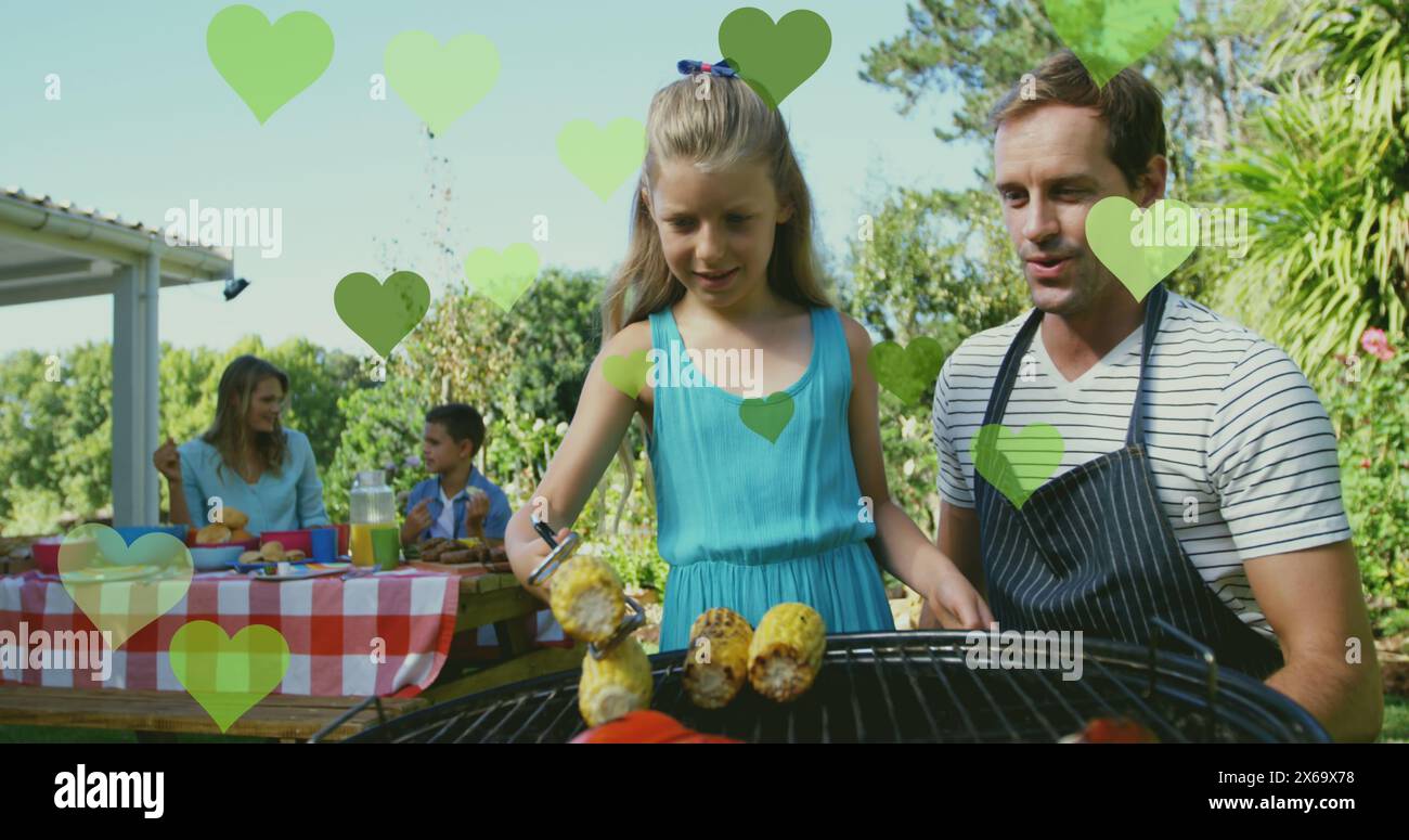 Image de cœurs sur heureux père caucasien et fille grillant Banque D'Images