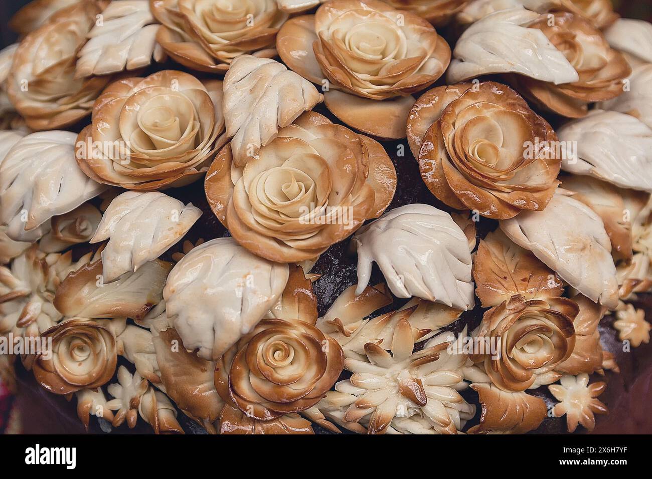 Fleurs faites de pâte sur un gros plan de gâteau de mariage. Culture ukrainienne Banque D'Images