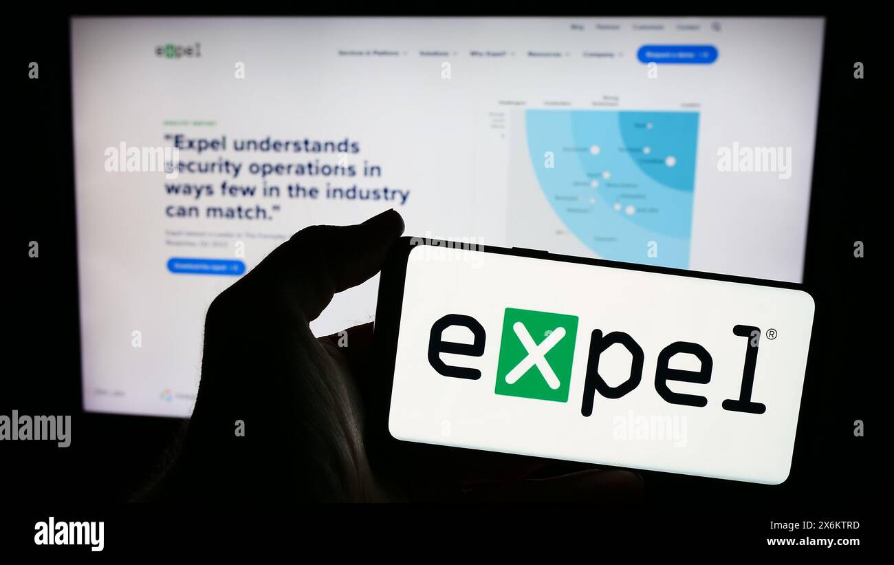 Personne tenant un smartphone avec le logo de la société américaine de cybersécurité EXPEL Inc devant le site Web. Concentrez-vous sur l'affichage du téléphone. Banque D'Images