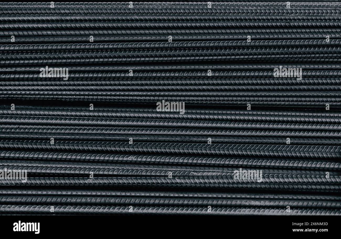 Barre ronde en acier renforcé. métal lourd, fond de texture de fer. construction d'armature de béton en barres d'acier noires. Banque D'Images