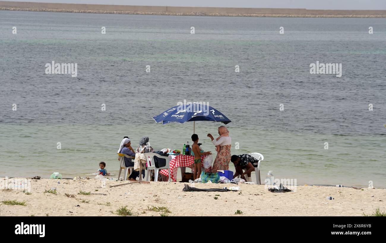 Tripoli, Libye. 15 mai 2024. Les gens apprécient le temps libre au bord de la mer à Tripoli, Libye, le 15 mai 2024. L'air chaud affecte la plupart des régions du pays selon le Centre National de météorologie en Libye. Crédit : Hamza Turkia/Xinhua/Alamy Live News Banque D'Images