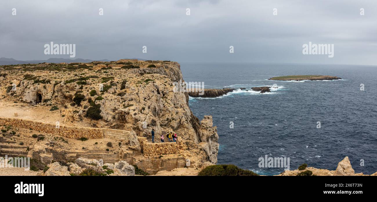 Espectacular paisaje desde el Faro del Cabo de Cavalleria. Junto a los acantilados, una familia disfrutando de las Vistas. Minorque, España Banque D'Images
