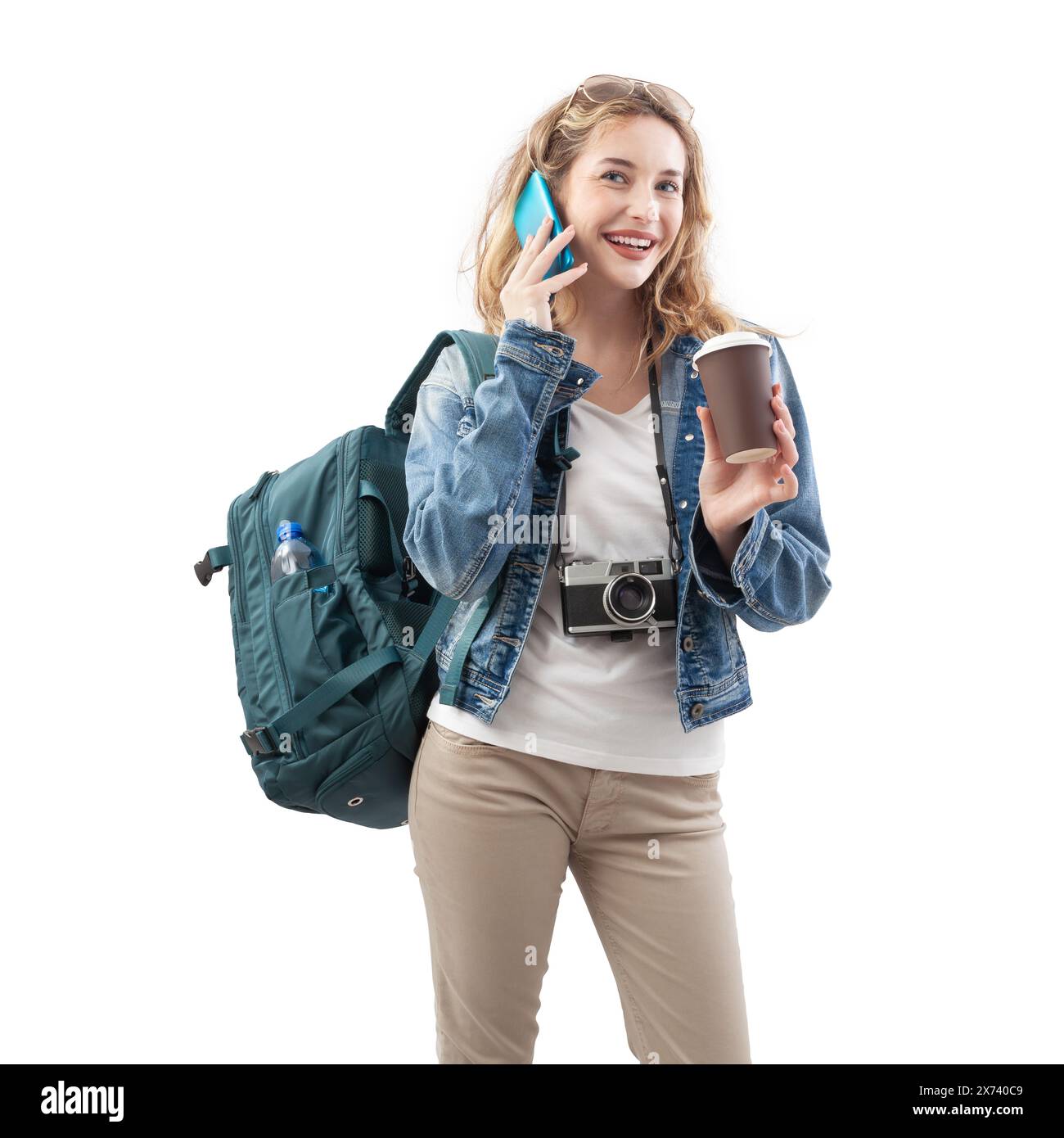 Heureuse jeune femme voyageuse touristique avec smartphone, tenant une tasse de papier et buvant du café, portant un sac à dos sur les épaules, isolé sur backgrou blanc Banque D'Images