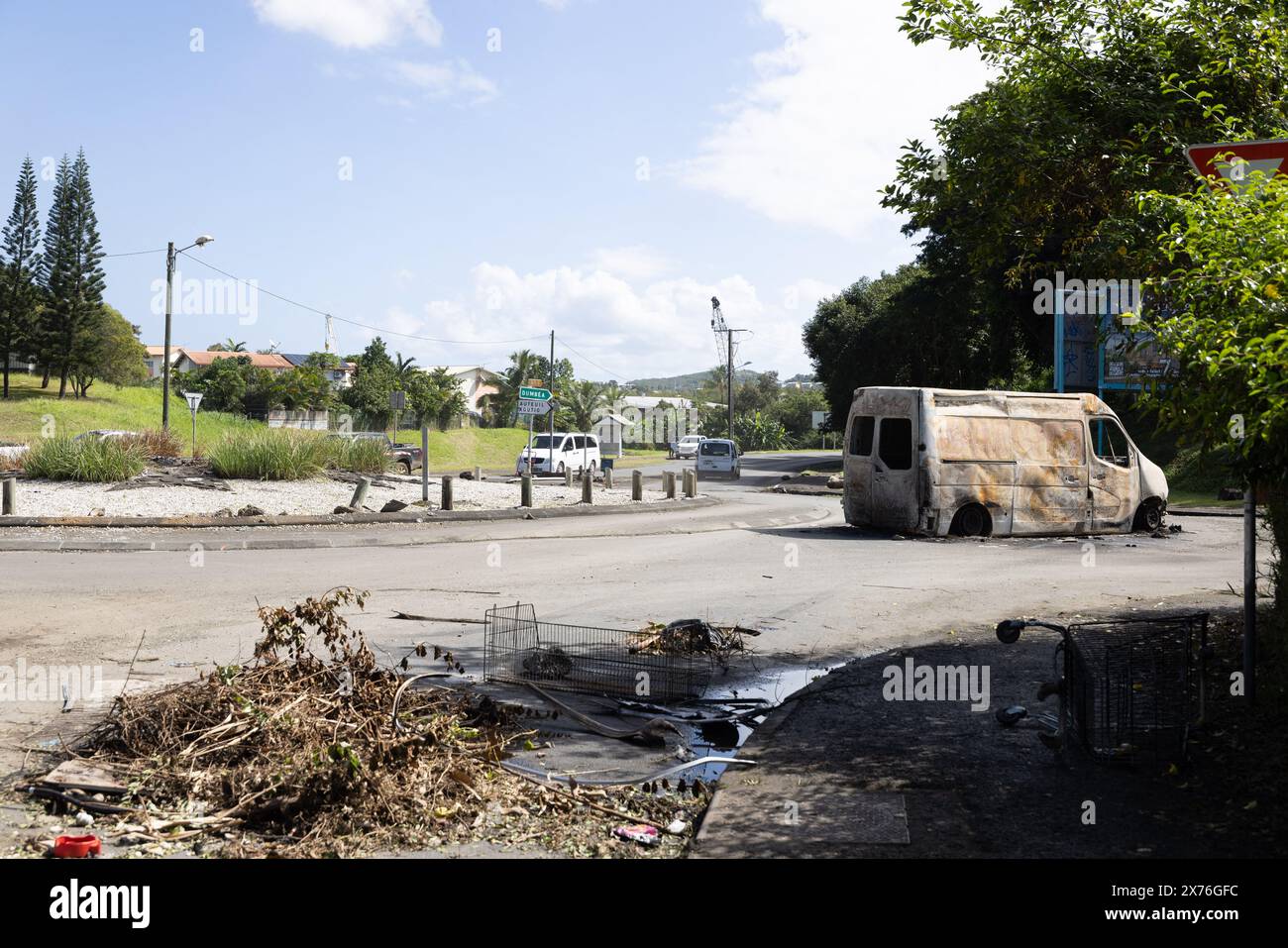 Samedi 18 mai 2024 - Dumbea - les restes de carcasses brûlées entravent la circulation des citoyens de Koutio. Une autre personne a été tuée samedi et deux autres blessées dans le territoire français Pacifique de la Nouvelle-Calédonie alors que le personnel de sécurité tentait de rétablir l'ordre après une cinquième nuit d'émeutes et de pillages qui a maintenant coûté la vie à six personnes. Pendant près d'une semaine, la ville habituellement tranquille de bord de mer a été convulsée. Deux gendarmes ont été tués : un coup de feu à la tête et un second coup de feu ami, ont indiqué les responsables. Trois autres personnes, toutes des Kanaks indigènes, ont également été tuées : un jeune de 17 ans et deux hommes ag Banque D'Images