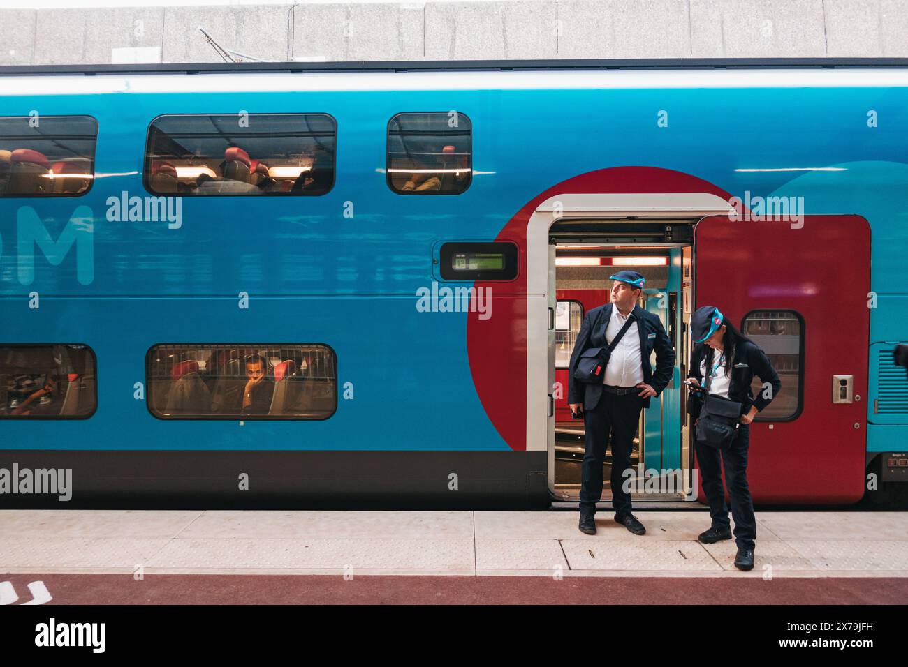 Des conducteurs attendent à la porte d'un train de voyageurs à bas prix Ouigo à la gare de Metz-ville, France Banque D'Images