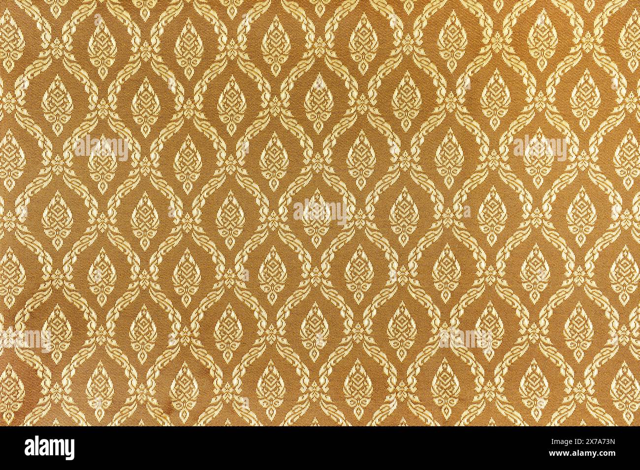 Fond abstrait et texture de motif thaïlandais de tissu doré. Banque D'Images