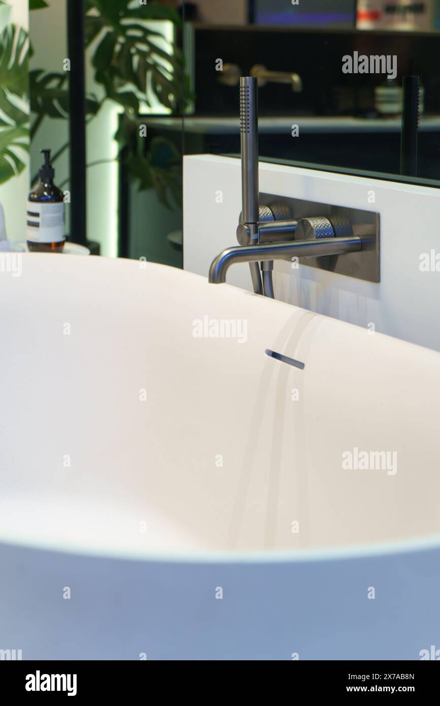 Combinaison moderne douche et baignoire conçue pour le luxe et la commodité, elle dispose d'un élégant boîtier en verre, luminaire contemporain Banque D'Images