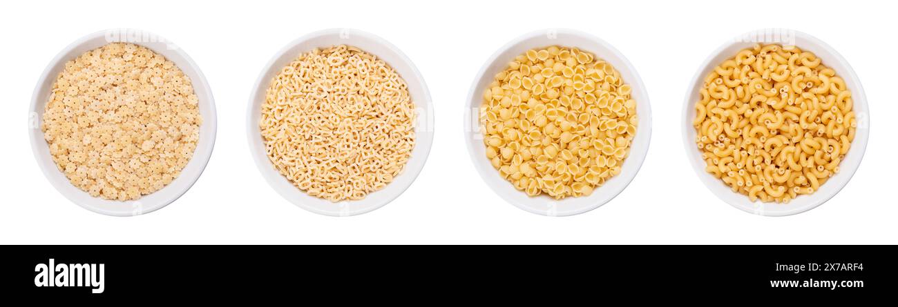 Variantes de pastina, pâtes italiennes, dans des bols blancs. Pâtes minuscules non cuites, faites de semoule de blé dur. Stelle, alfabeto, perline et gramigna. Banque D'Images