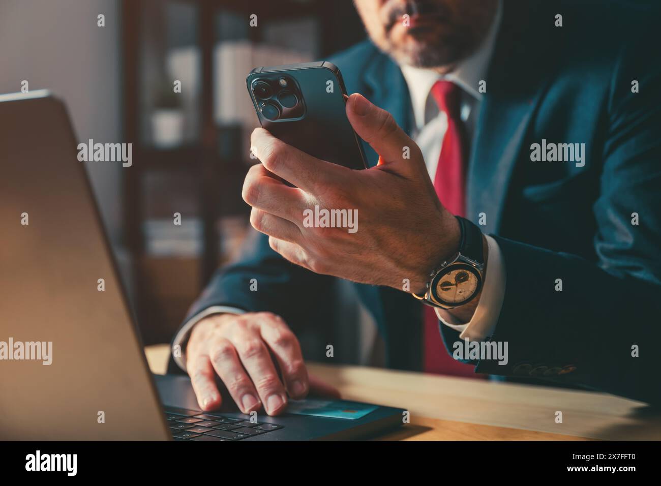 Homme d'affaires travaillant avec smartphone et ordinateur portable dans le bureau, focus sélectif Banque D'Images