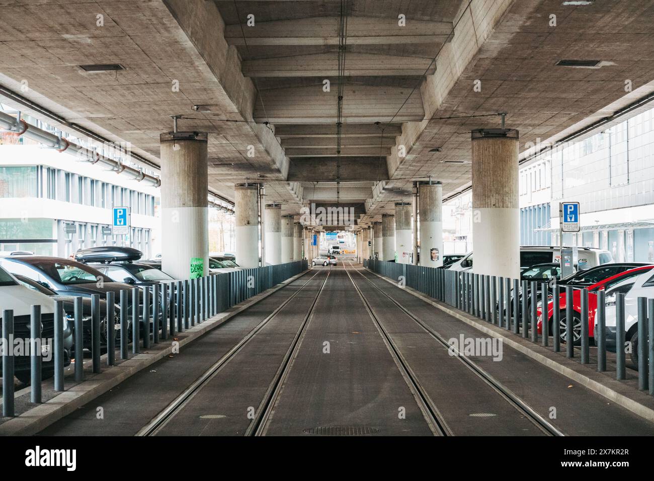 Vue sur les voies de métro léger à la gare de Schiffbau, Zurich. Une route à plusieurs voies passe au-dessus du sol, soutenue par des piliers en béton Banque D'Images