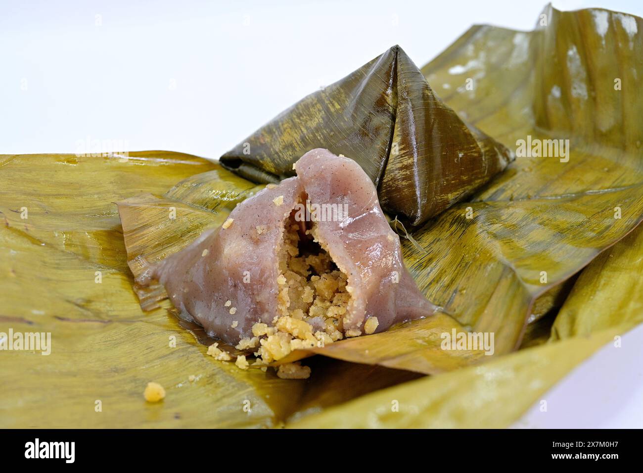 Khanom thian est une petite boulette de farine de forme conique cuite à la vapeur dans une feuille de banane originaire du nord de la Thaïlande. Généralement rempli d'un mung salé Banque D'Images