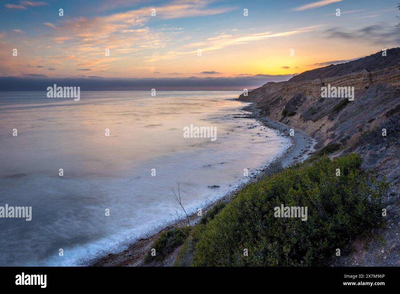 Embarquez pour un voyage serein le long du Catalina Trail, où le coucher de soleil paisible illumine les falaises accidentées et la splendeur côtière de Ocean Trails Rese Banque D'Images