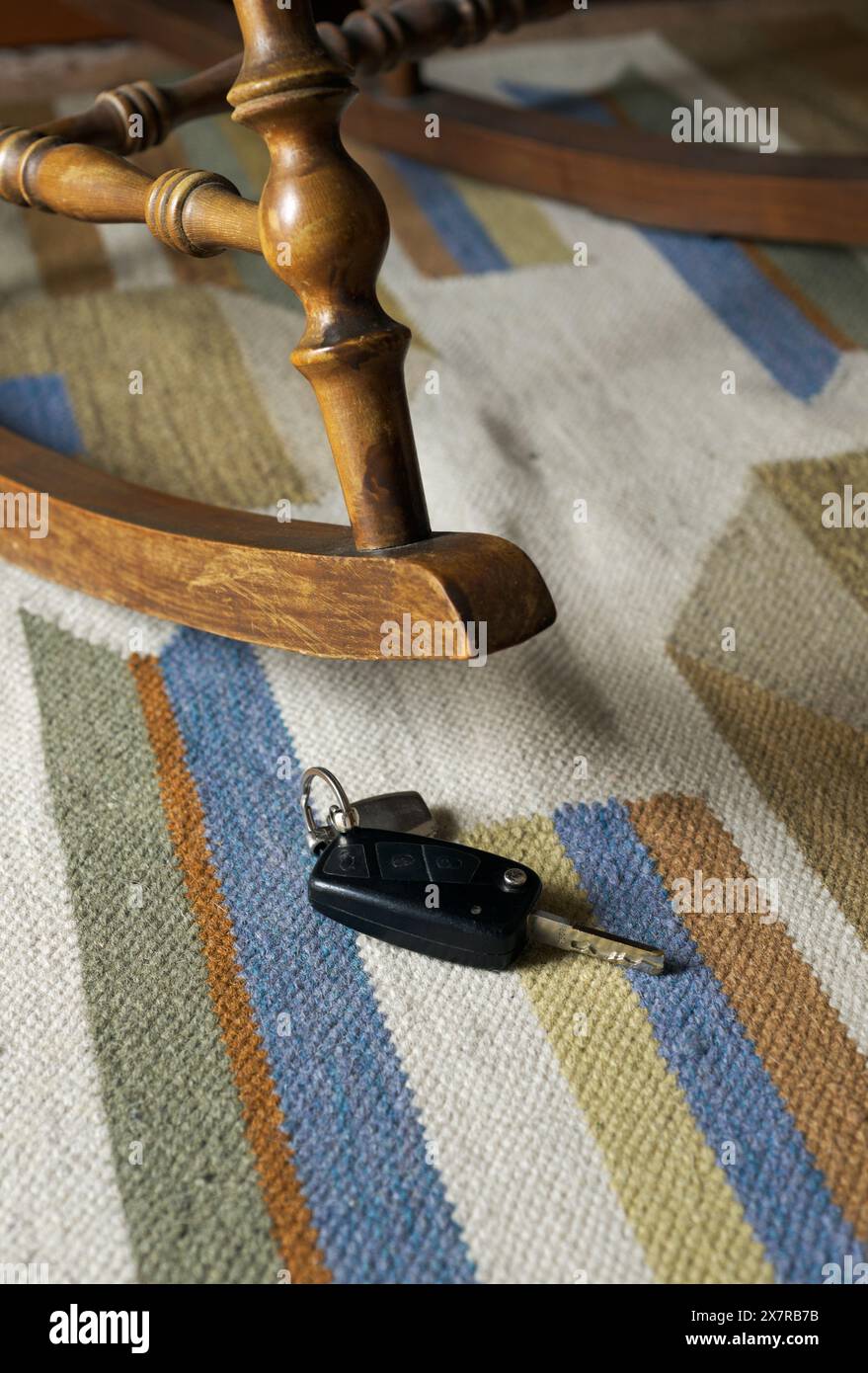 Clé de voiture sous fauteuil à bascule Banque D'Images