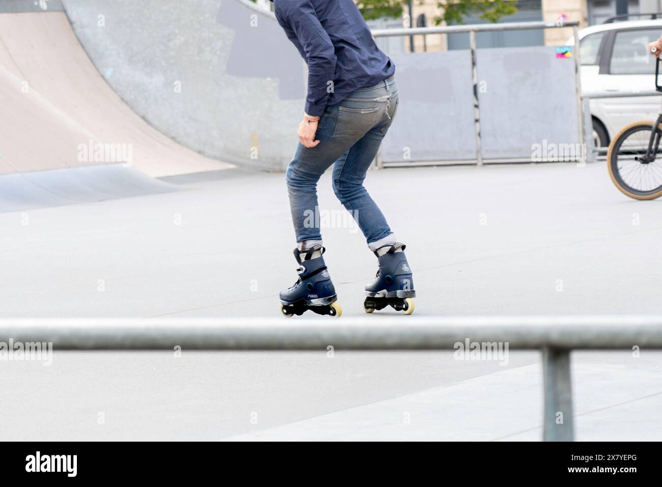 Les gens au skatepark extérieur, patiner et faire des tours sur les rampes Banque D'Images