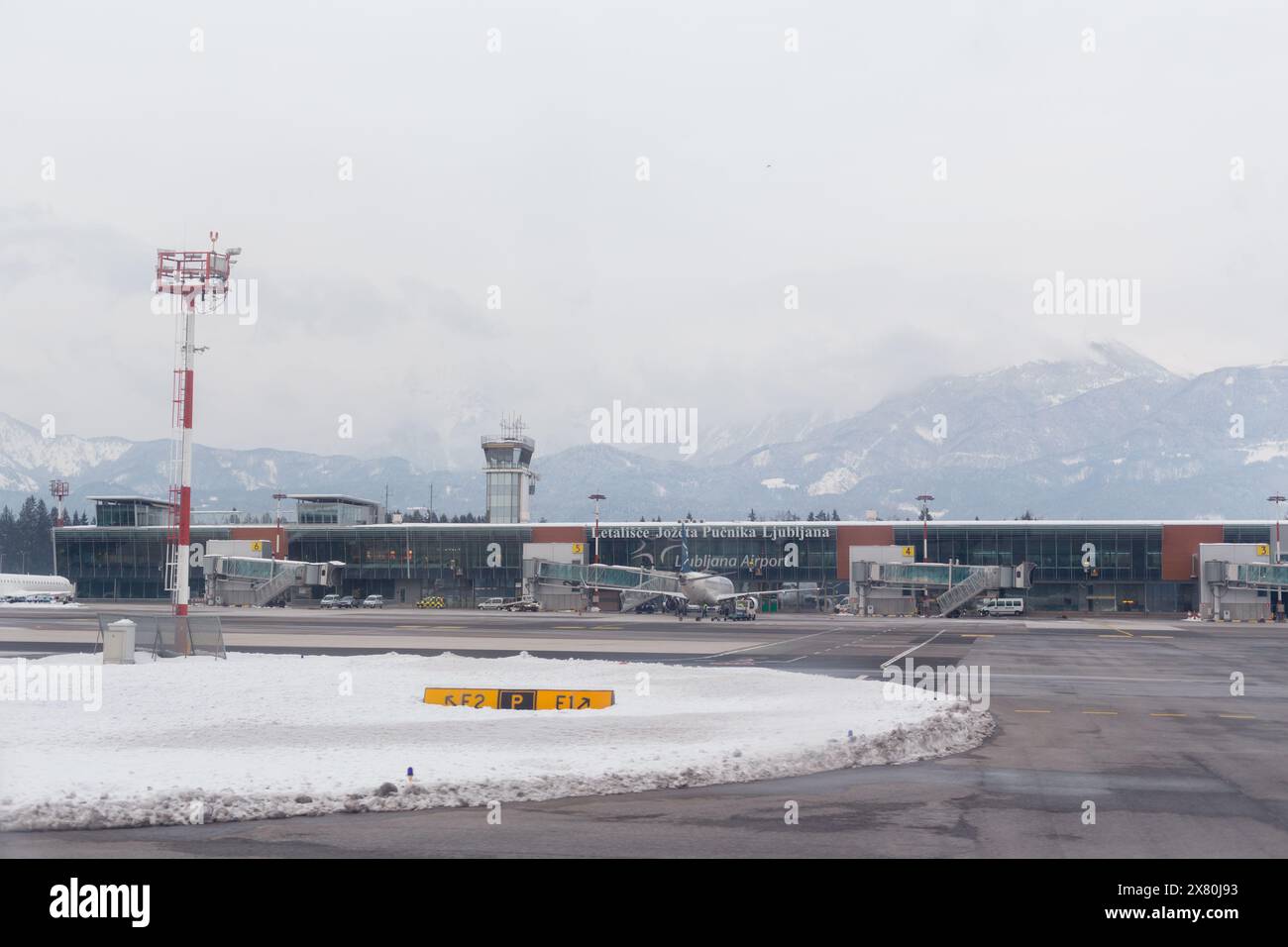 Brnik, Slovénie - 13 février 2018 : terminal passagers à l'aéroport de Ljubljana de Joze Pucnik dans la neige hivernale Banque D'Images