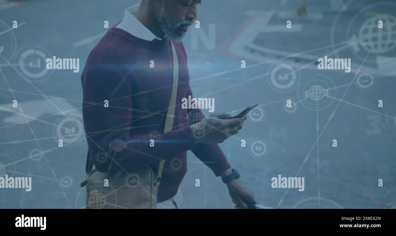 Image d'icônes connectées sur afro-américain tenant un vélo et utilisant un téléphone portable Banque D'Images