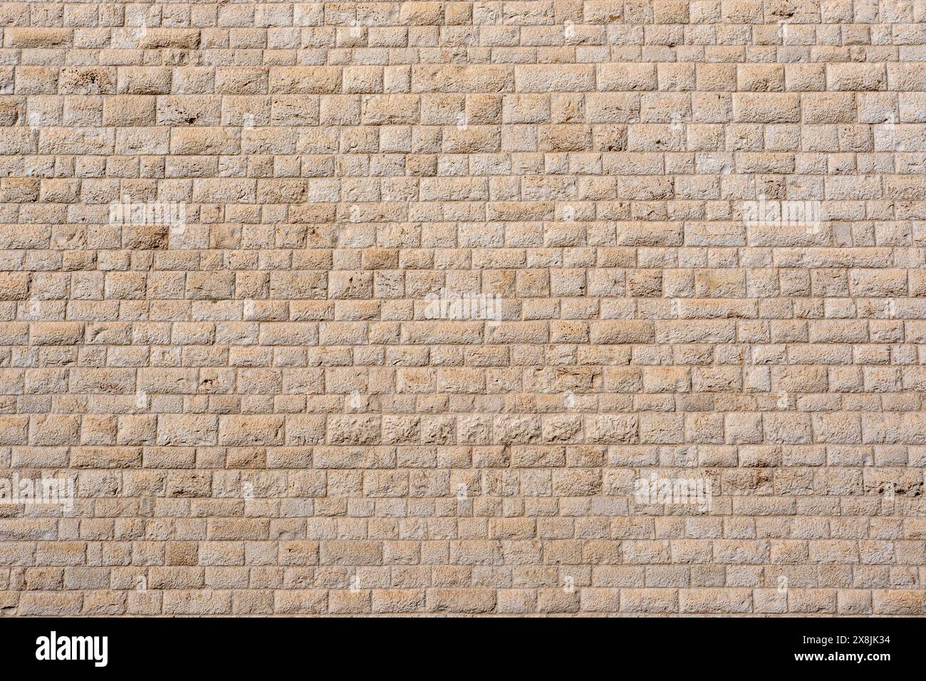 Arrière-plan d'un vieux mur de pierre régulier Banque D'Images Arrière-plan d'un vieux mur de pierre régulier Banque D'Images