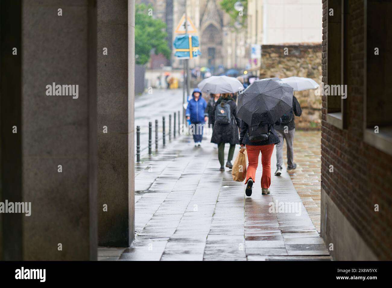 Les gens en route pour travailler par temps pluvieux à Cologne Banque D'Images