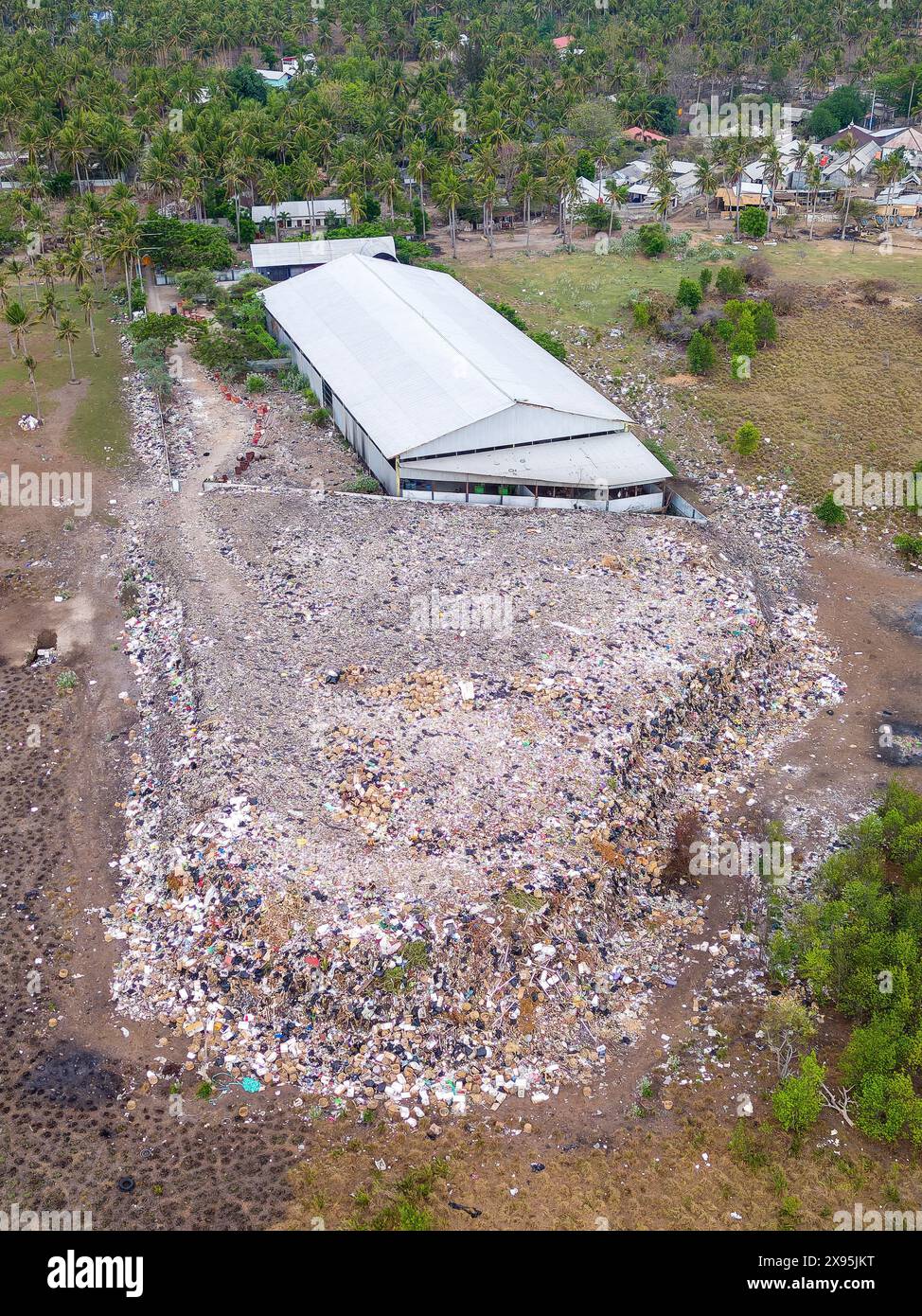 Vue aérienne d'une grande décharge débordante sur une petite île tropicale Banque D'Images