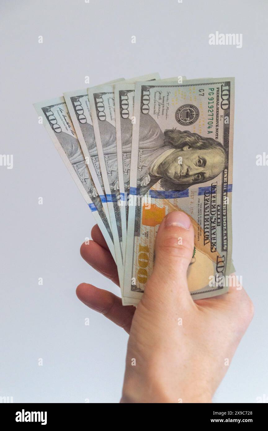 5 cent dollars US tenus dans sa main droite. Banque D'Images