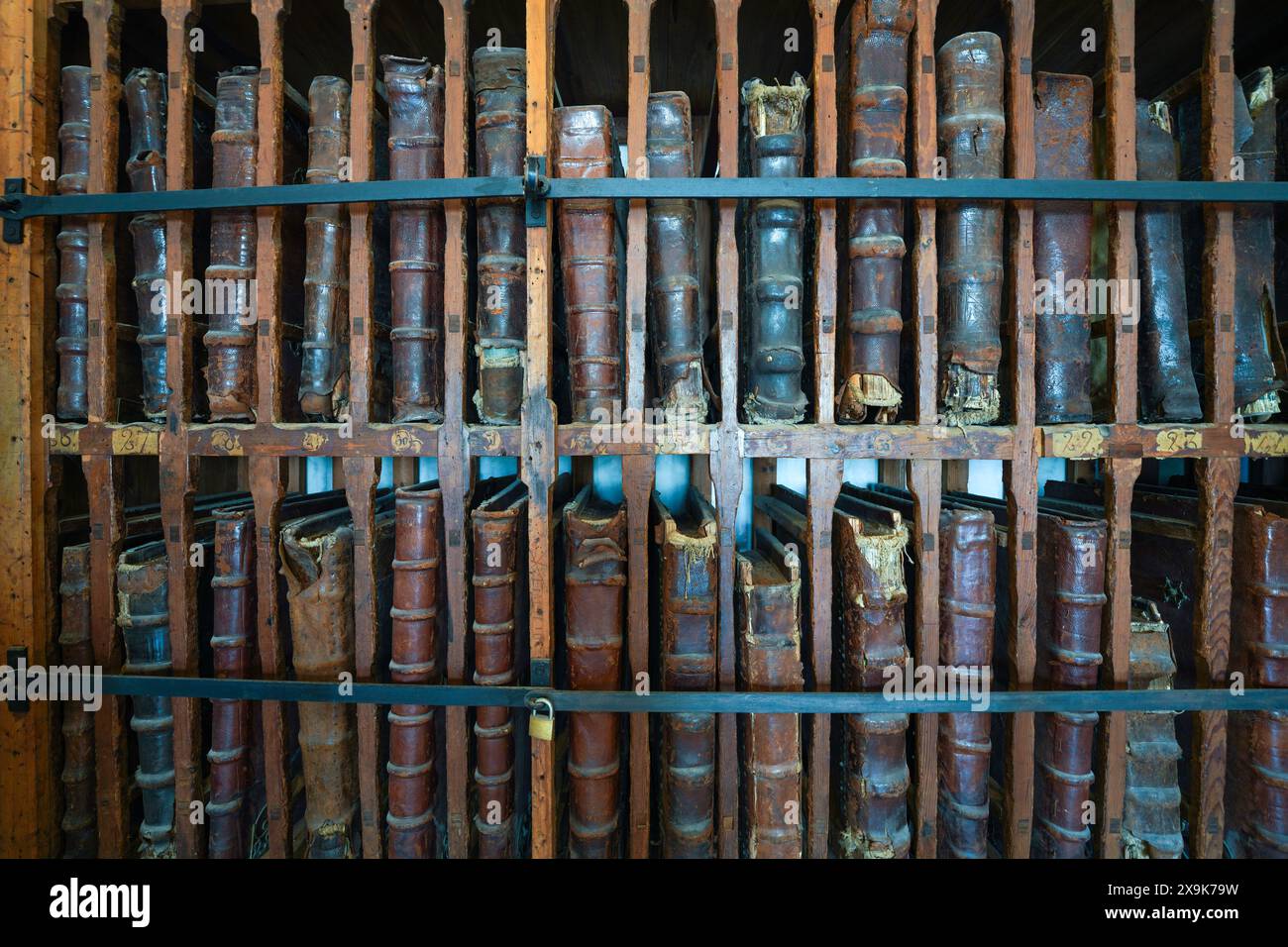 Étagère remplie de vieux livres à couverture rigide reliés en cuir. Une bibliothèque de plusieurs, de multiples grands livres antiques rares, une collection de livres anciens vieillis. Banque D'Images