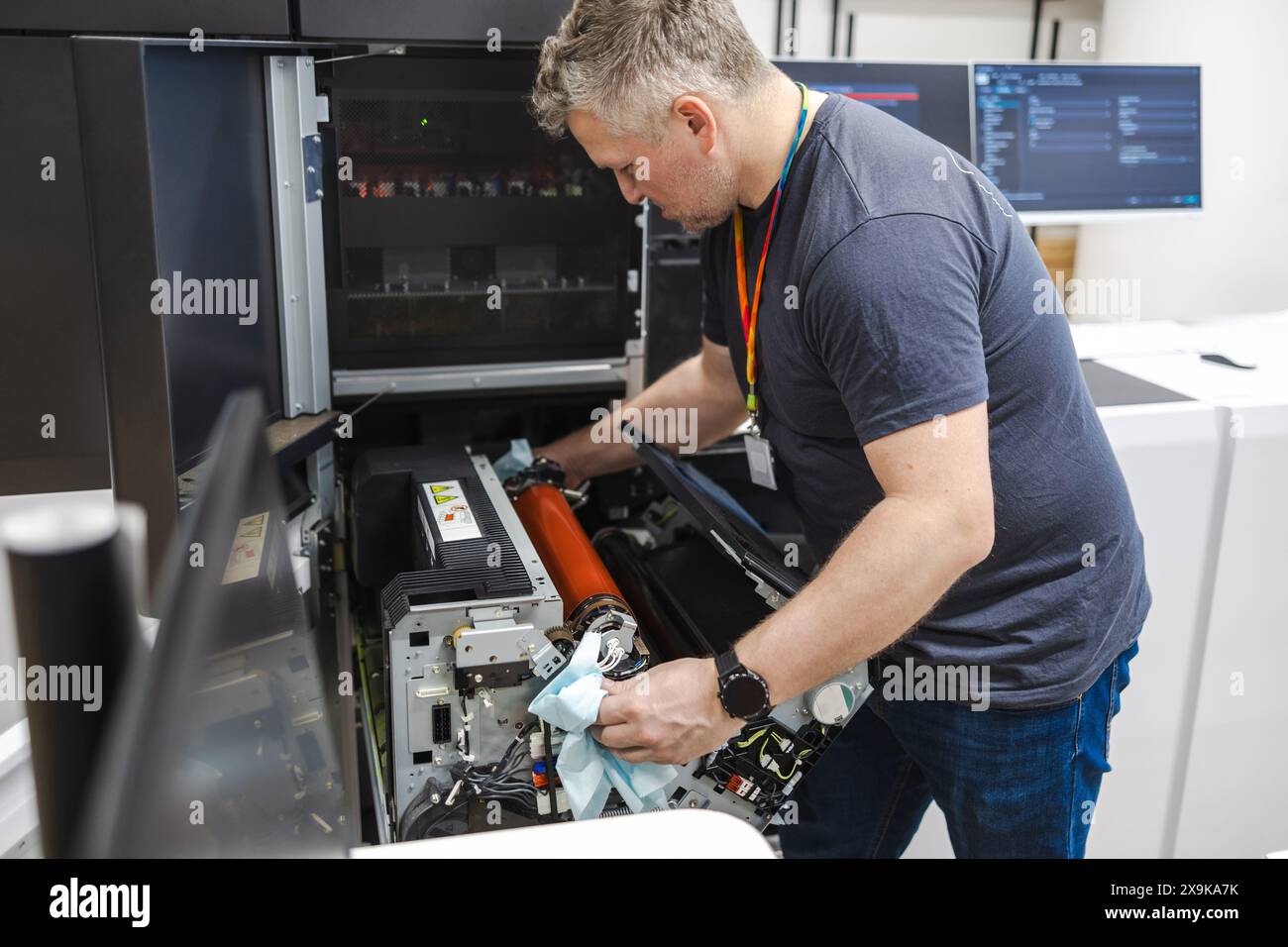 Ingénieur de maintenance dans une machine de fixation de maison d'impression Banque D'Images