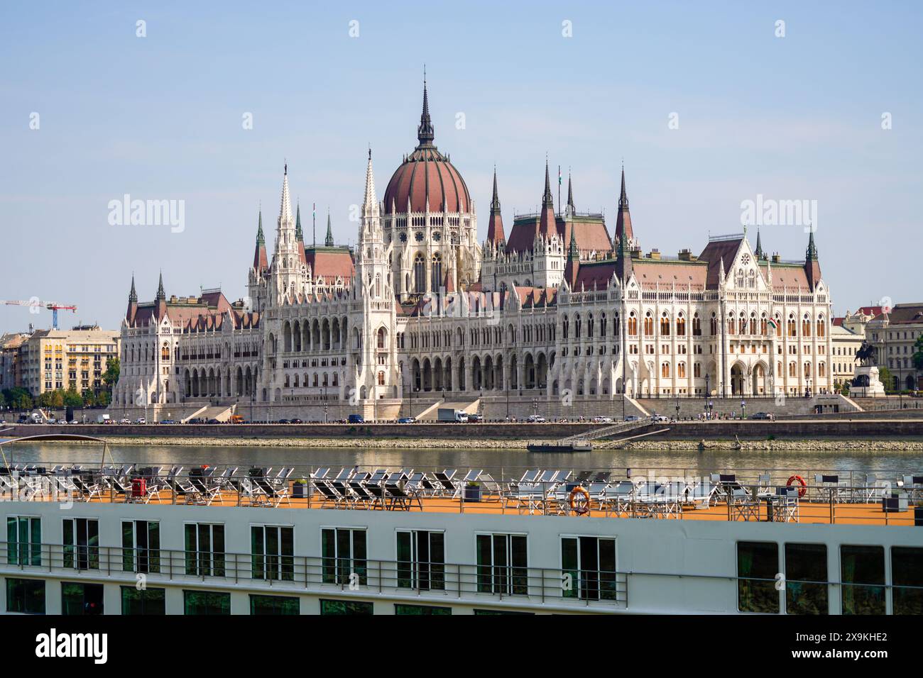 Bâtiment du Parlement hongrois, connu sous le nom de Parlement de Budapest avec un pont de bateau à aubes vide avec des chaises sur le Danube. Jour, pas de gens. Banque D'Images