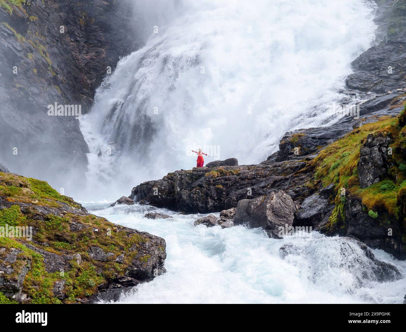 Femme dansant devant la cascade de Kjosfossen en Norvège Banque D'Images