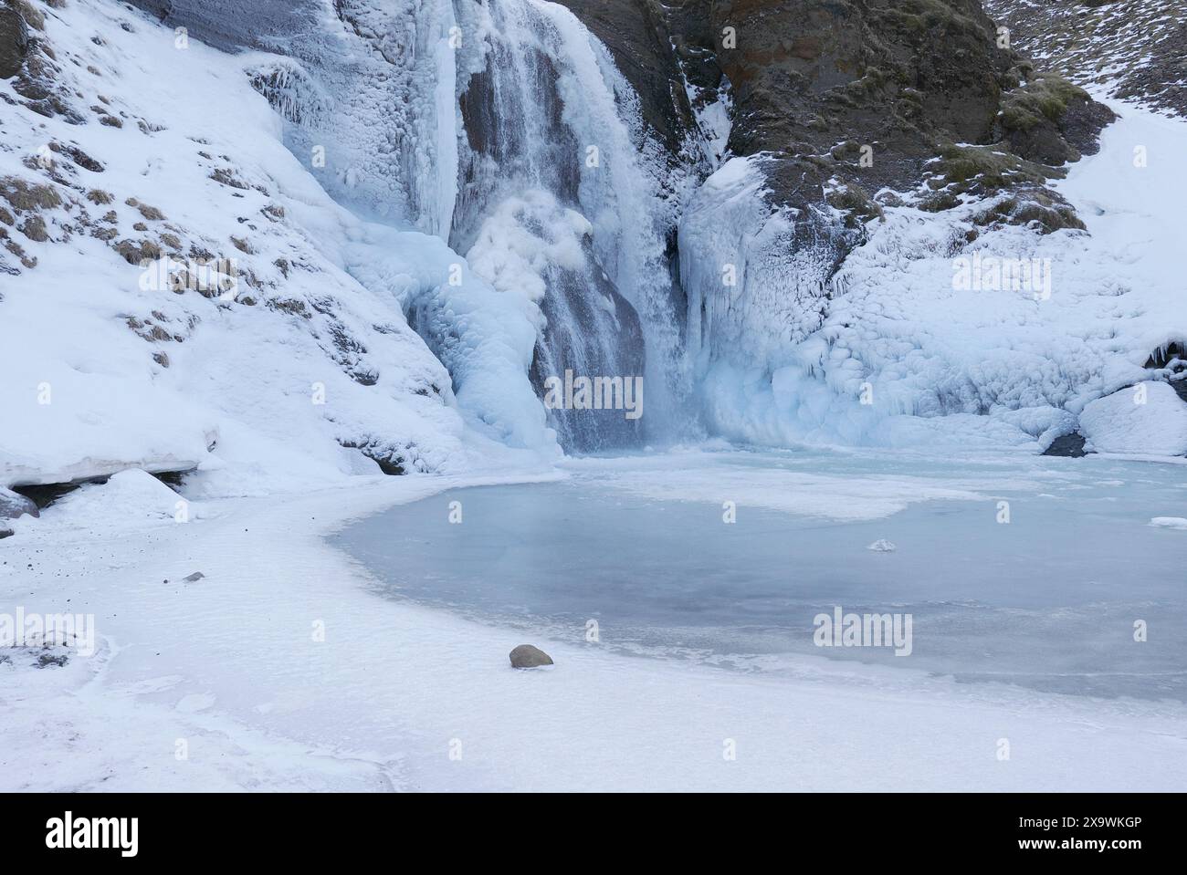 . Cascade Helgufoss couverte de glace au début du printemps. Islande Banque D'Images