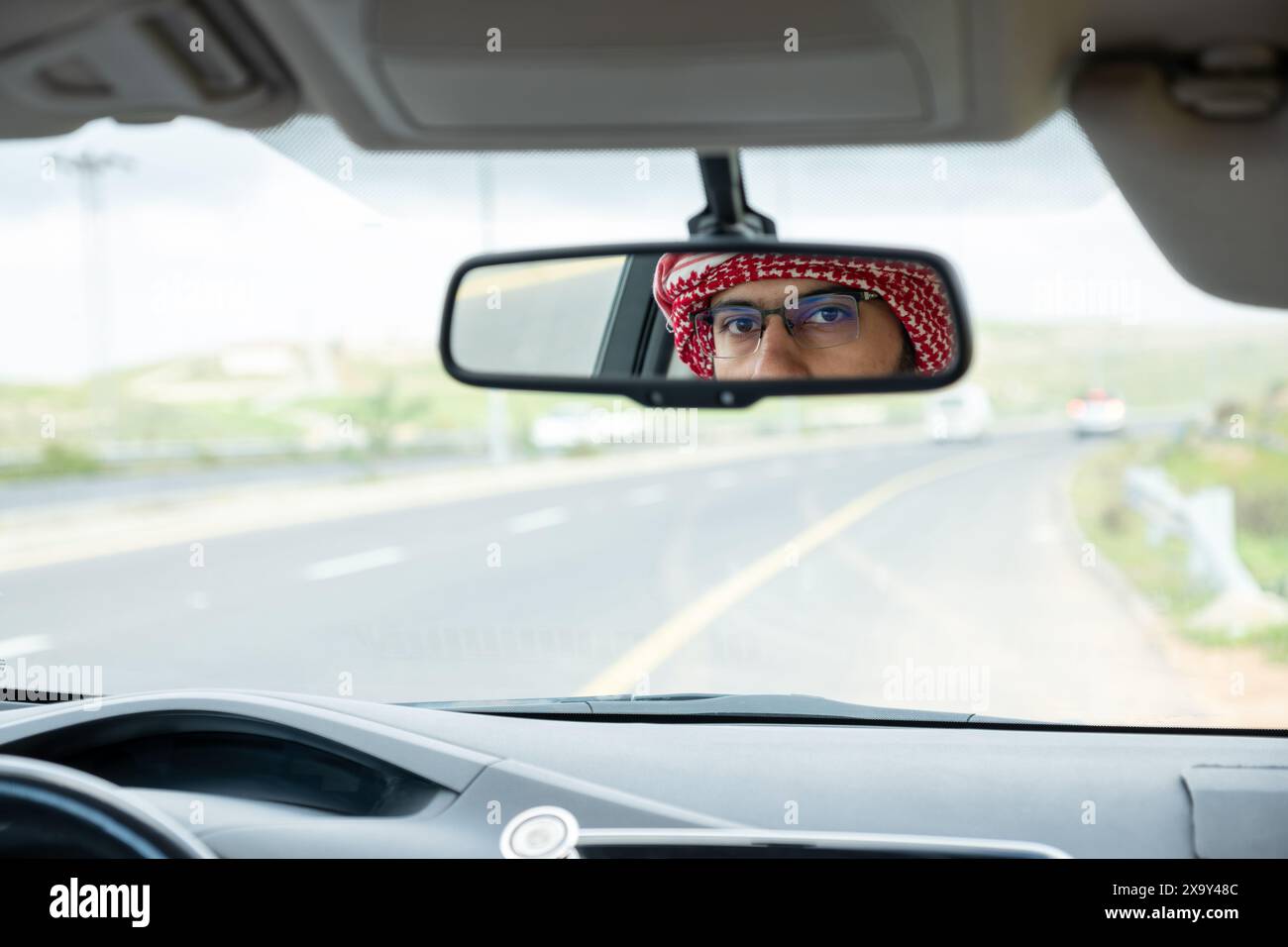 Chauffeur arabe joyeux dans sa voiture Banque D'Images