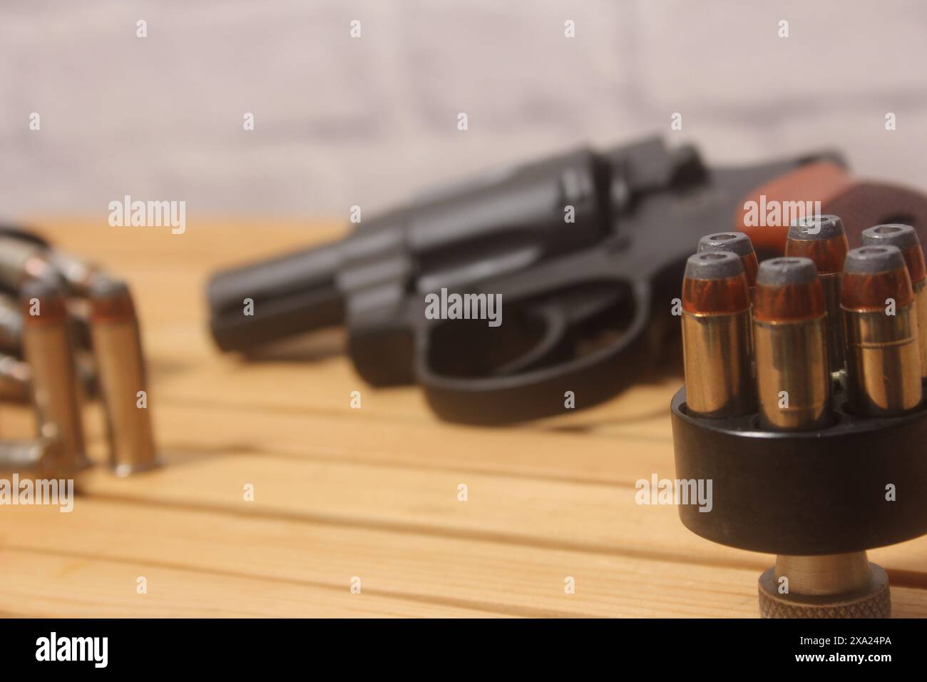 Un pistolet et des balles sur une table en bois Banque D'Images