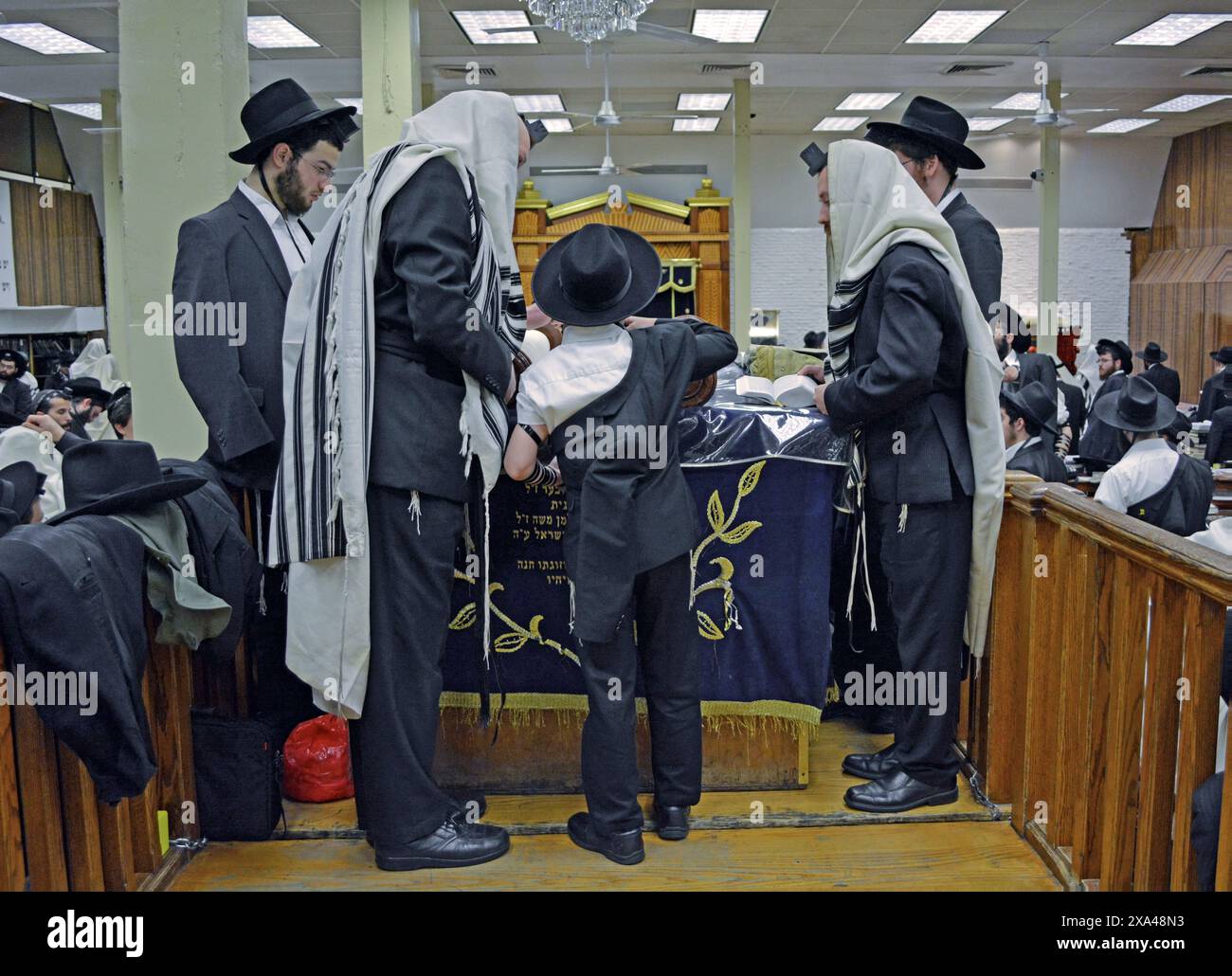 Un garçon juif orthodoxe est appelé à la Torah pour sa Bar Mitzvah. Lors d'un service en semaine à la synagogue principale de Chabad sur Eastern Parkway à Bklyn, New York. Banque D'Images