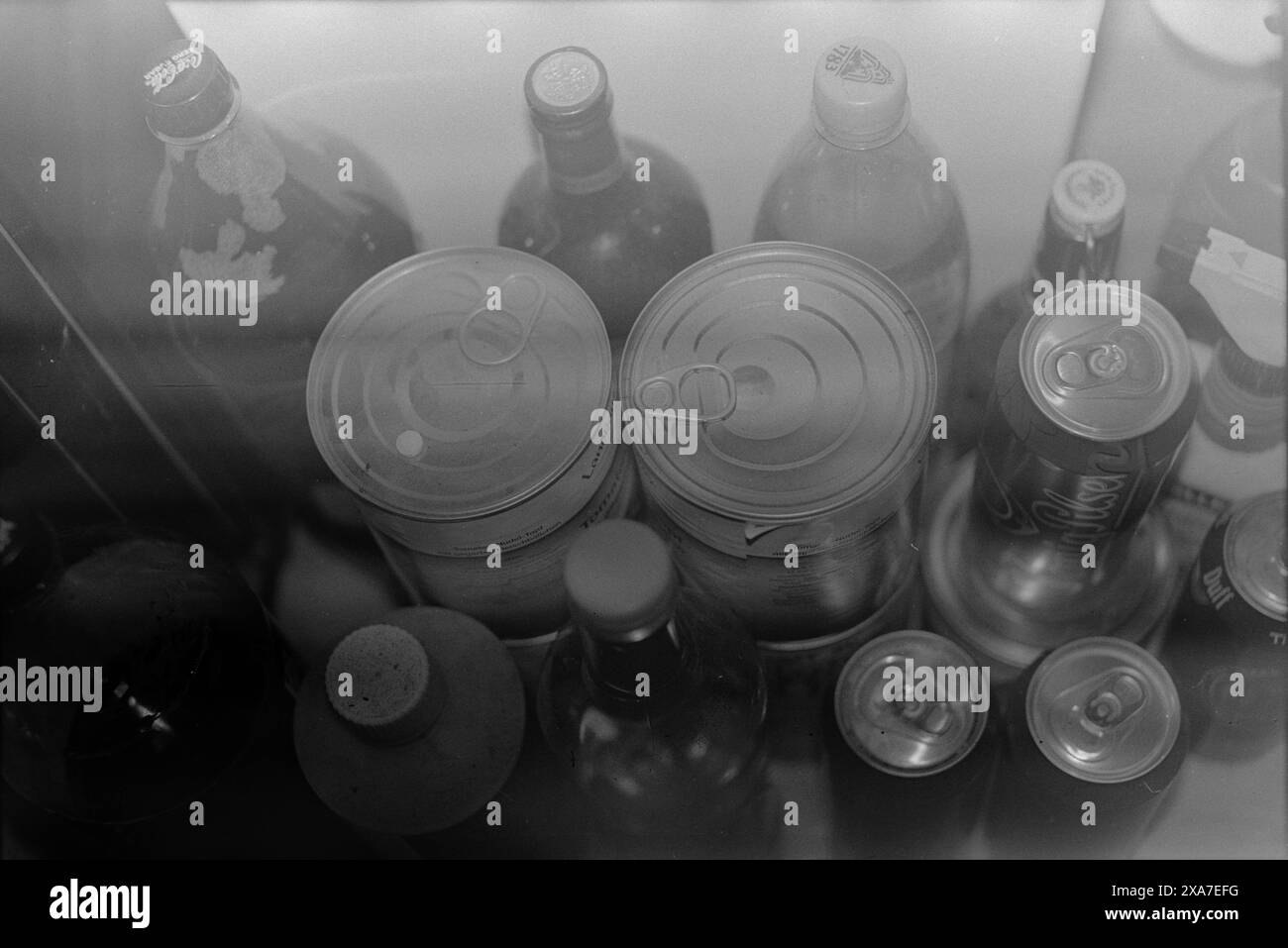 Une image monochrome de bouteilles et de canettes Banque D'Images