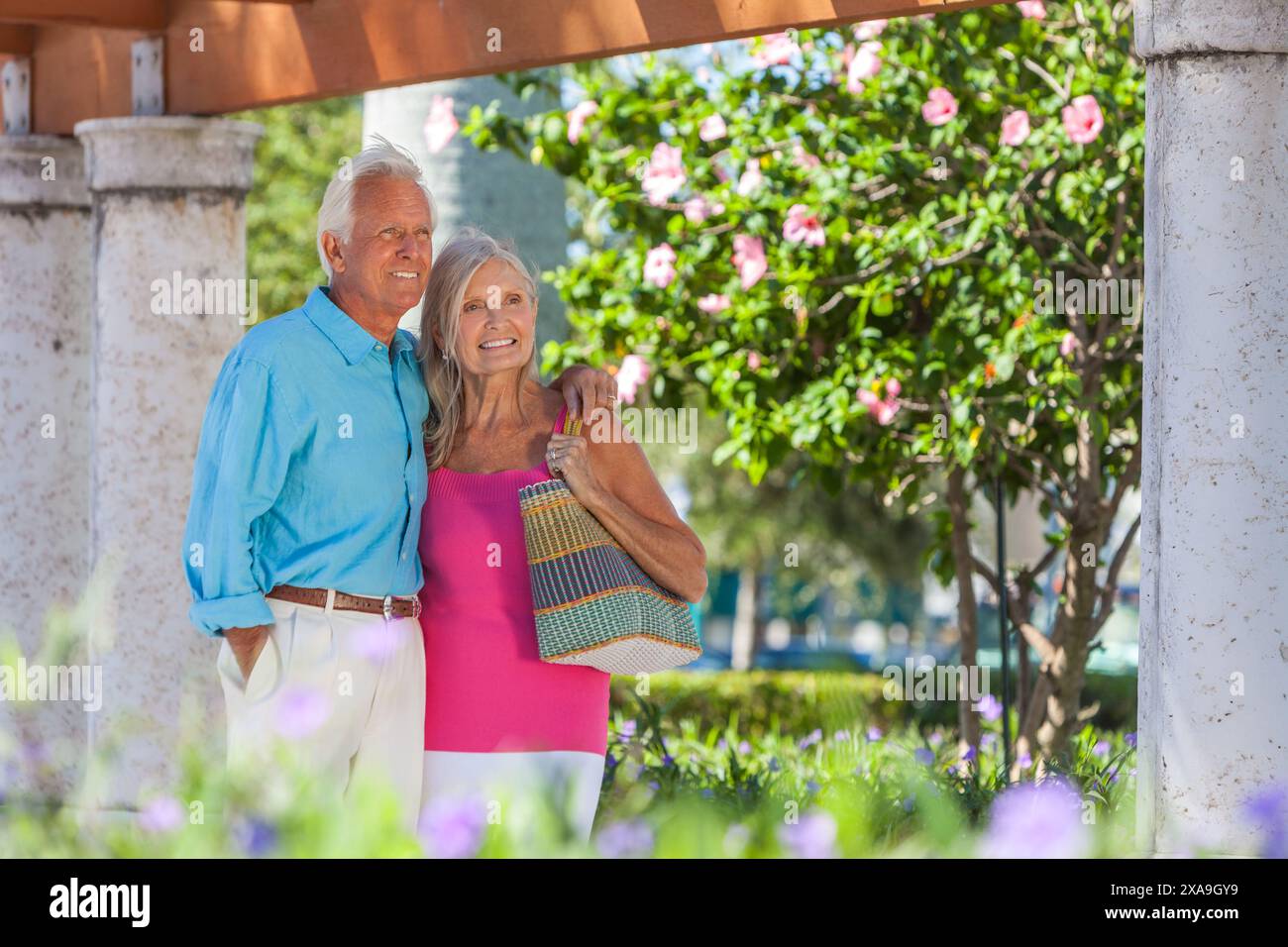 Heureux homme senior et femme vieux couple marchant ensemble dehors au soleil Banque D'Images