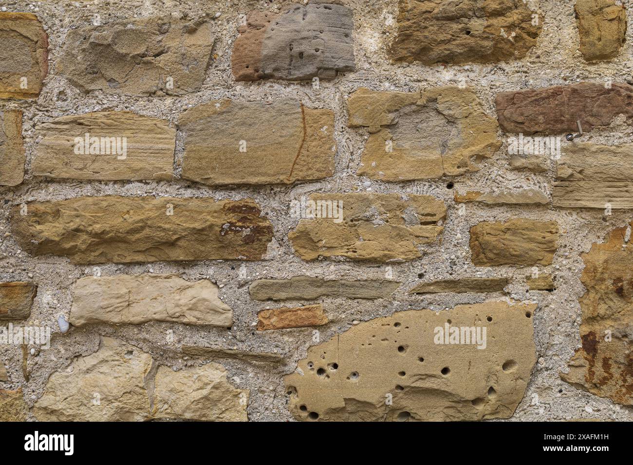 photographie à plat en gros plan d'une roche brun beige et d'une surface murale en grès Banque D'Images