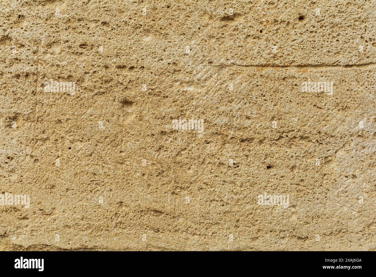 photographie à plat en gros plan d'une surface de grès jaune beige, fond texturé de roche de sable antique Banque D'Images