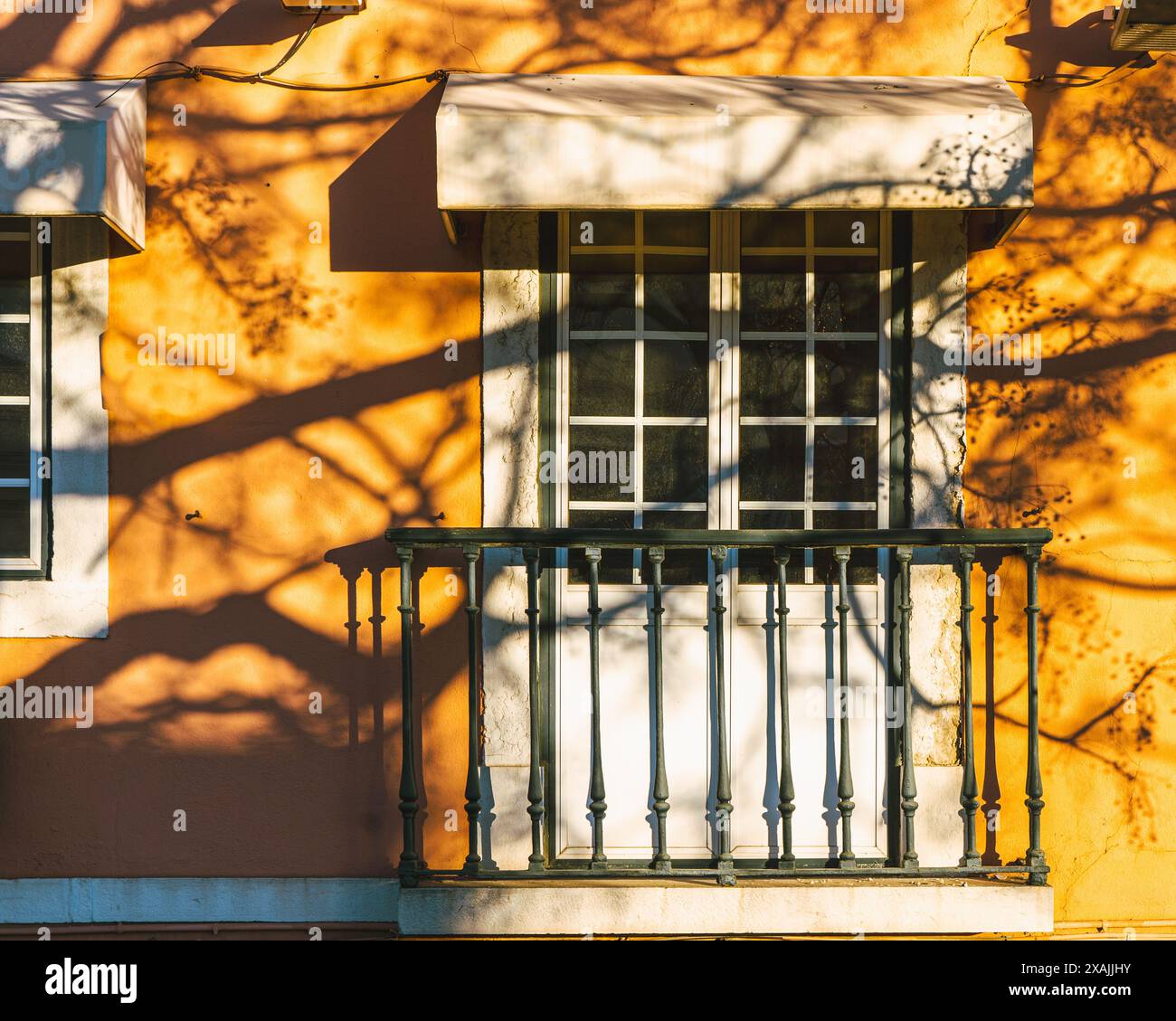 Jeu d'ombres sur une maison jaune de Lisbonne, ambiance ensoleillée Banque D'Images