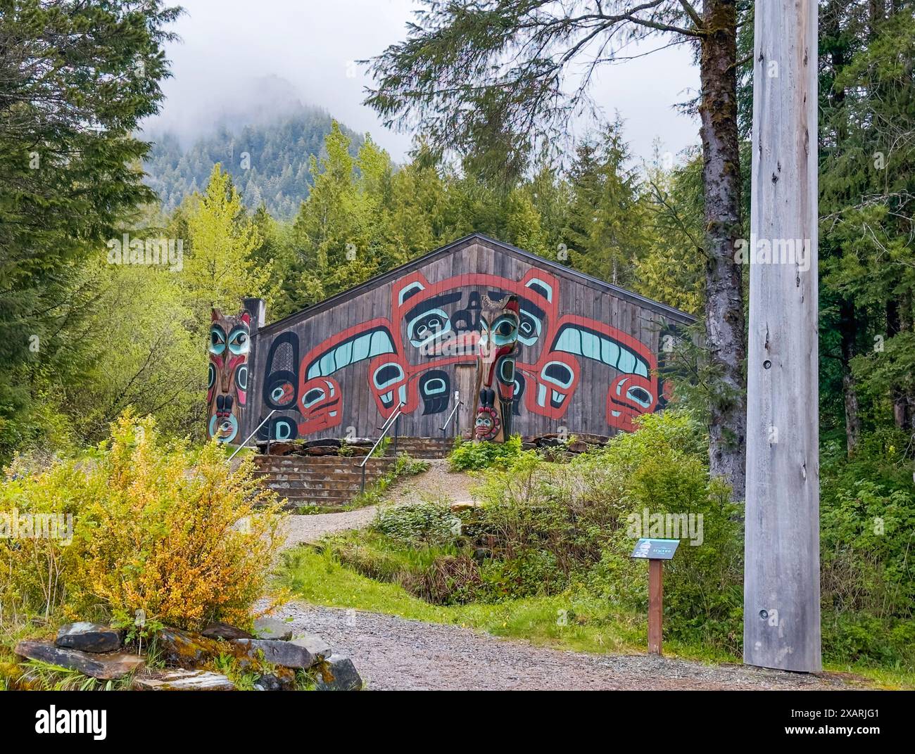 La maison du clan des Indiens Tongass à Ketchikan, Alaska, montre la maison d'hiver, les totems et le totem Seward dans le parc d'État de Saxman. Le bâtiment historique est peint. Banque D'Images