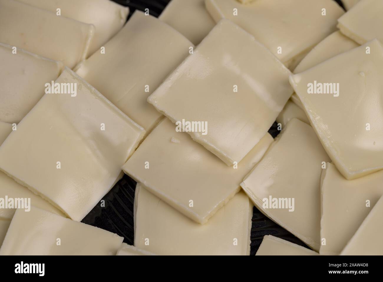 Chocolat blanc fondu avec beurre et poudre de lait, fondant des morceaux de chocolat blanc à haute température Banque D'Images